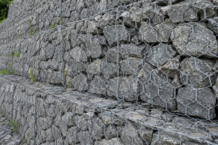 Close view of stone placement inside a gabion structure