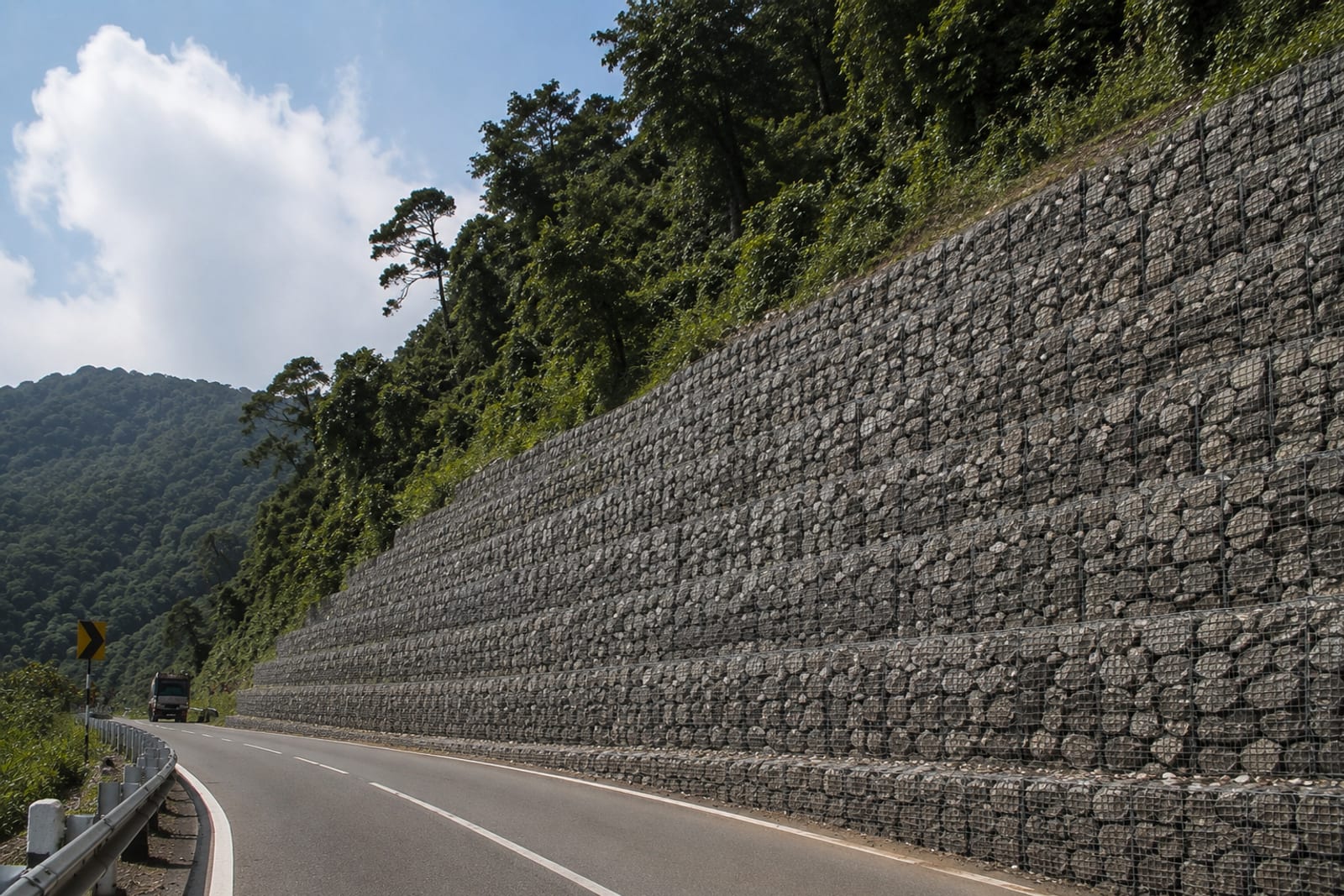 Stone retaining structure along a highway slope-protection area